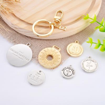 China Engraved Logo Metal Label Name Tags Customized Metal Circle Logos Tag for Handbags for sale