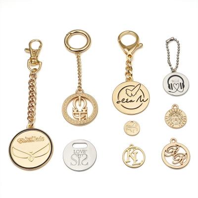 China Customized Size Handbag Luxury Round Engraved Metal Hang Tag Logo Label Eco-friendly for sale