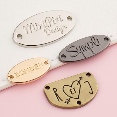 China Metal Tag for Clothing Accessories 2 Hole Sew Custom Logo Label Bikini Abaya Swimwear for sale