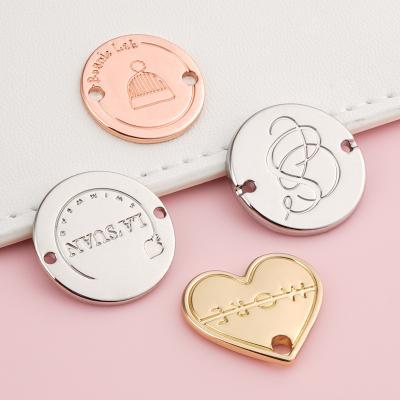 China Washable Custom Metal Tags For Clothing Label Rose Gold Circle Label for sale