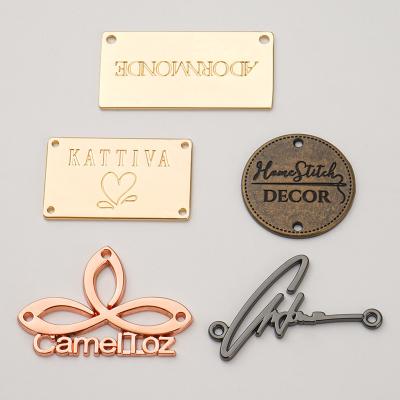 China Shiny Finished Gold Metal Tag For Customized Swimwear Clothing Branding for sale