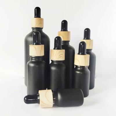 China Matte Black Glass Dropper Bottles empty cosmetic with dropper caps and rubber top for essential oil perfume for sale