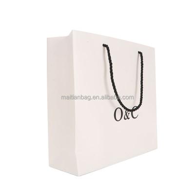 China Recyclable custom logo eco kraft paper boutique shopping gift reusable luxury retail carry paper bag with handles for sale