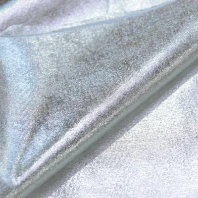 China Fashion style 180gsm luxury gold polyester spandex stretch silver foil FDY stretch foil knitted fabric for apparel decoration for sale