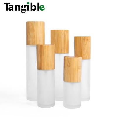 China Cosmetic Refillable Roll On Transparent 10ml Perfume Essential Oil Clear Frosted Roller Glass Bottles With Bamboo Lid Cap for sale