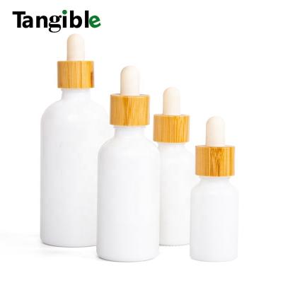 China 5ml Cosmetic 10ml 15ml 20ml 30ml 50ml 100ml Frosted Essential Oil White Glass Bottle With Lid Pipettes Dropper Bamboo Cap for sale