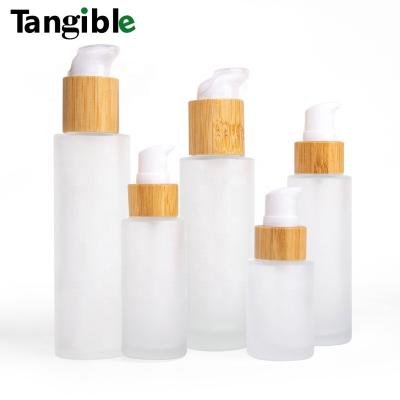 China New Developed Cosmetic Frosted Wooden Bamboo Cap Round 10ml 30ml 50ml Clear Glass Bottle With Lotion Pump for sale