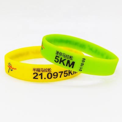 China All Ink Injected Rubber Bracelet Custom Logo debossed fill Silicone Wristband Carving Marathon running sports group activities for sale