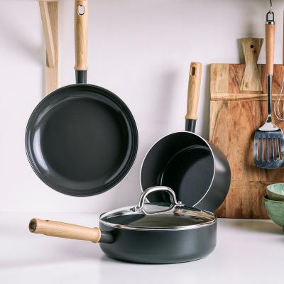 China Non Stick 4pcs Sustainable Cookware Set Amazon Success Kitchen Wear Black Aluminum Cookware Set With Wooden Hanlde for sale