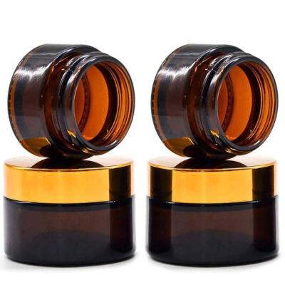 China Shiny gold aluminum cap 15g clear jars low moq 15ml big unique sale beauty and cosmetic containers amber glass jar with lids sealed metal aluminum lid for sale