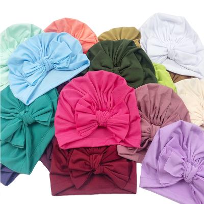 China Lovely 21colors Lovely Bow Turban Tied Bow Hat Spring Headwear Infant Newborn Beanies Comfy Toddler Baby Girls Kids Bow Caps for sale