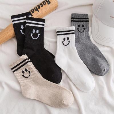 China Fashion Breathable Wholesale Solid Color Tube Socks Custom Logo Smiley Face Men Sports Crew Socks Breathable Non Slip for sale