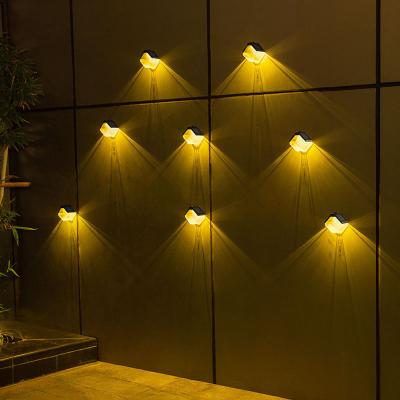 China Solar Powered Led Garden Wall Lamp Indoor Sensor Outdoor Decorative Warm Garden Fence Lamp for sale