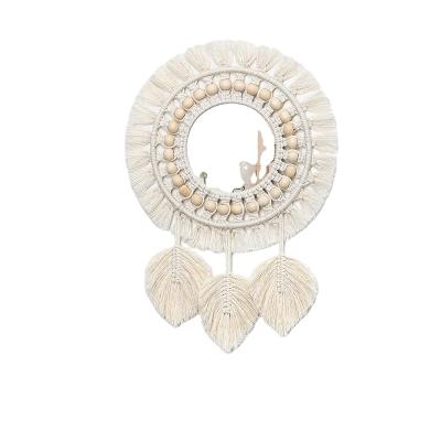 China Decorative Minimalist Boho Macrame Fringe Round Mirror with Wooden Beads Feather Pendant for sale