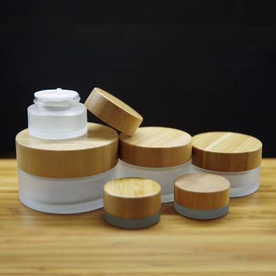 China Eco-friendly Cosmetics Packaging Containers Lid Design Wooden Bamboo Jar 15g 20g 30g 30g 100g Frosted Body Cream Clear Glass Cosmetic Jar for sale