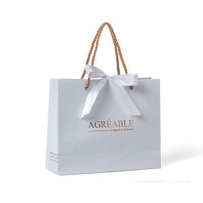 China Recyclable Retail Shopping Bag Apparel White And Gold Custom Embossed Gift Bag Jewelry Logo Wedding Gift Bags for sale