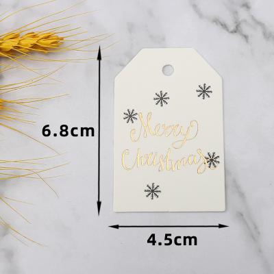 China Viable Shape Custom Logo Printed Paper Label Design Gift Tag Swing Gold Foil Luxury Merry Christmas Label For DIY Decoration for sale