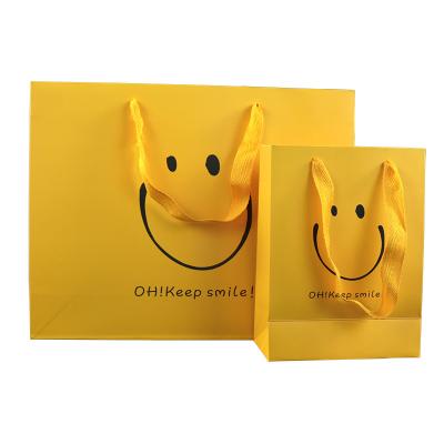 China Recyclable Wholesale Customized Creative Wedding Gift Bag Smile Paper Bag Packaging Shopping Paper Bag for sale