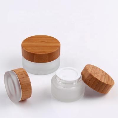 China Matte Cosmetics Glass Jar With Bamboo Lid Of Beautiful Luxury High Quality Cosmetic Screw Cap For Skin Care Cream for sale