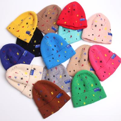 China New Arrival COMMON Winter Color Print Graffiti Hole Warm Acrylic Knitted Beanie Hat Outdoor Unisex Design for sale