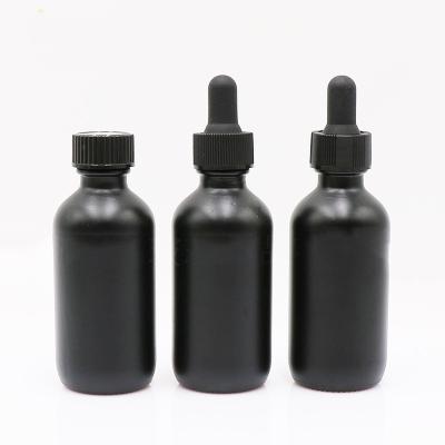 China Daily Life 60ml 2oz Stored Essential Oil Glass Black Frosted Bottle With Dropper Black Lid And Storage Lid for sale