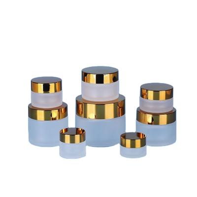 China Cosmetic Cream Transparent Glass Cosmetic Packaging Containers And Jars With Golden Caps for sale