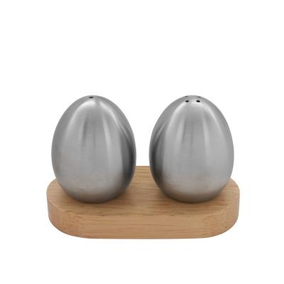 China Wooden Kitchenware Rack Egg Shape Stainless Steel Pepper Salt Shaker Set for sale