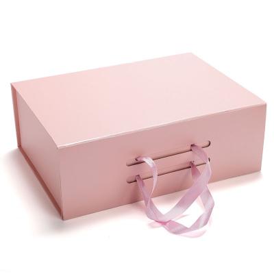 China Recyclable Paper Clothes Paper Suitcase Gift Box With Handle for sale