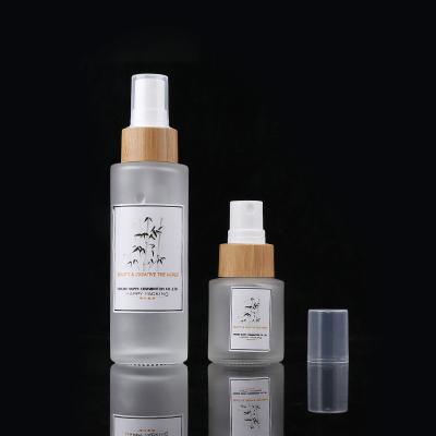 China 15ml Cosmetic Natural Cosmetic Spray Bamboo Frosted Glass Bottle With Bamboo Pump for sale