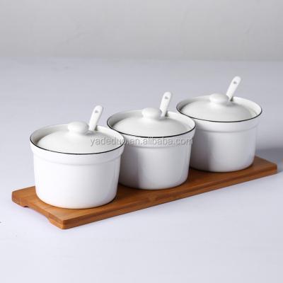 China Customized Simple White Ceramic Porcelain Spice Seasoning Jar Simple Condiment Set With Lid And Wood Rack For Kitchen Spice for sale