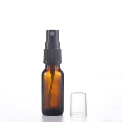 China Personal Care Cylinder Glass Bottles Amber Essential Oil Perfume Bottles With Spray Top for sale