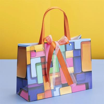 China Wholesale Premium Quality Recyclable Gift Maker Paper Gift Packaging Bag With Ribbon Handle Bow for sale