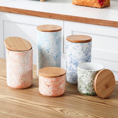 China Nordic Cylindrical Tea Container Coffee Cereal Steamable Colorful Glazed Ceramic Kitchen Food Storage Jars With Wooden Lid for sale