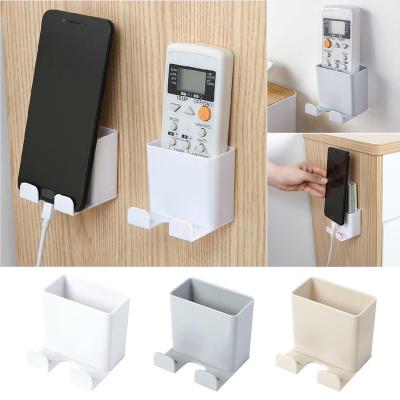 China Viable Wall Mounted Mobile Phone Bracket Remote Control Holder No Phone Support Mobile Phone Drilling Charging Stand for sale