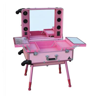 China Professional Waterproof Makeup Rolling Case With Lights And Legs Standing Aluminum Cosmetic Trolley Case In Pink Color for sale