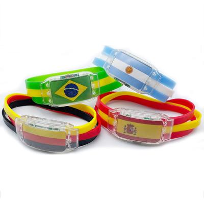 China 2022 Promotional Gifts Qatar World Cup Flag Wristband Fans Cheering Props Silicone Flash LED Wristband Wristband Wholesale for sale