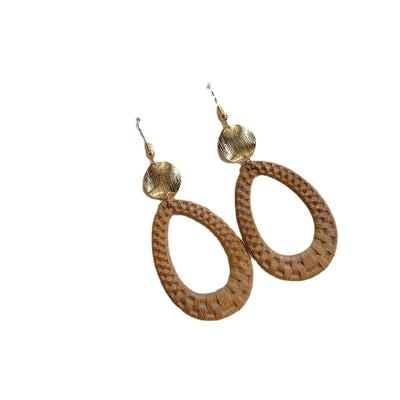 China HOLIDAY Simple Geometric Round Wind Rattan All-match Retro All-match Temperament Metal Splicing Wooden Dangle Earrings for sale