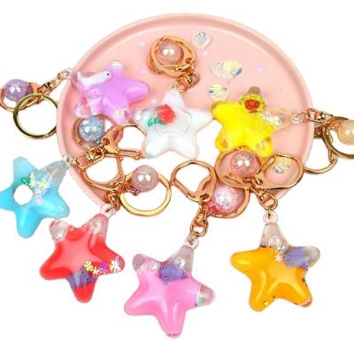 China Fasion Hog ​​Quicksand Milk Star Pentagon Creative Rafting Floating Floating Key Chain In Oil Car Bag Key Liquid Pendant for sale