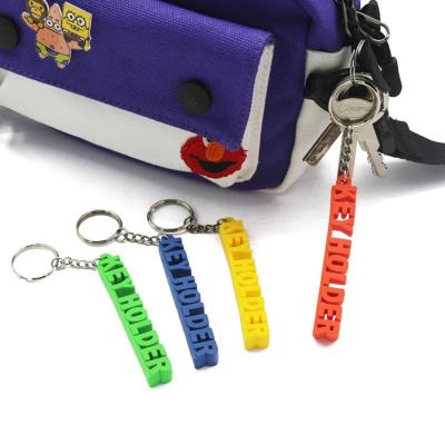 China Yiwu Gillian Custom 2d Text Status Quo Rubber Key Chain PVC 3d Soft Key Chain for sale