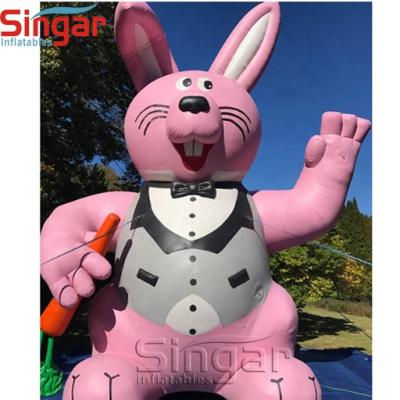 China Oxford Decoration Giant Inflatable Easter Bunny With Carrot Balloon For Yard Decoration for sale