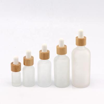 China 5ml 10ml 15ml 30ml 50ml 100ml natural personal care essential oil frosted cosmetics glass bottles with bamboo lid for sale