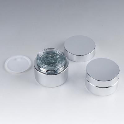 China Luxury Personal Care 30g 50g Logo Printing UV Silver Cosmetic Fancy Flat Glass Jars For Lip Balm Empty for sale