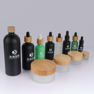 China High End Clear Frosted Glass Essential Oil Pump Bottle 5ml 15ml 30ml 50g 100G Personal Care Oil Pump Bottle With Bamboo Lid for sale