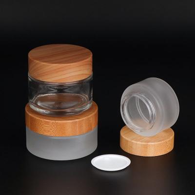 China Personal Care 10g 30g 50g 100g 2oz Bamboo Cosmetic Packaging 1oz Frosted Cream Glass Jars With Bamboo Lid for sale