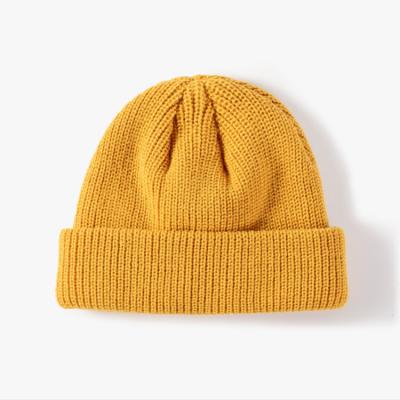 China COMMON Custom Logo Solid Color Skiing Warm Running Thick Knit Leather Winter Beanie Bowler Hat for sale