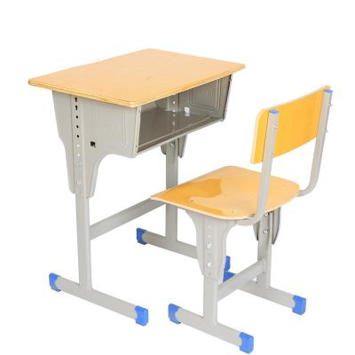 China Modern Hot Student SaleSchool Furniture Desks Permanent Deformation Plywood Classroom Table And Chair Cardboard Iron Tube Modern School Area for sale