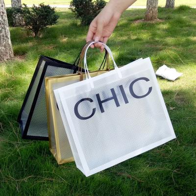 China PVC Recyclable Simple Portable Plastic Gift Packaging Bag Custom Logo Popular Transparent Portable Gift Bag for sale