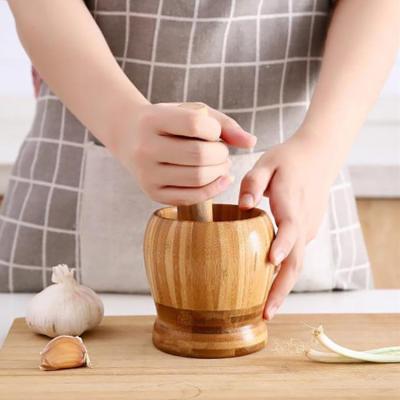 China Viable Multifunctional Manual Bowl Wooden Garlic Grinder Ginger Spices Press Pestle Grinder for sale