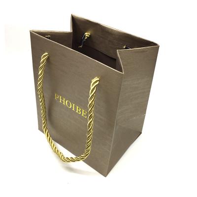 China Custom Recyclable Embossed Hot Stamping Foil Logo Gold Texture Paper Bag With Gold Rope Handle for sale