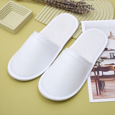 China Exquisite Disposable Hotel Amenities Personalized Sole Closed Toe Guest Disposable Slippers Napped Fabric Indoor Hotel Slippers for sale